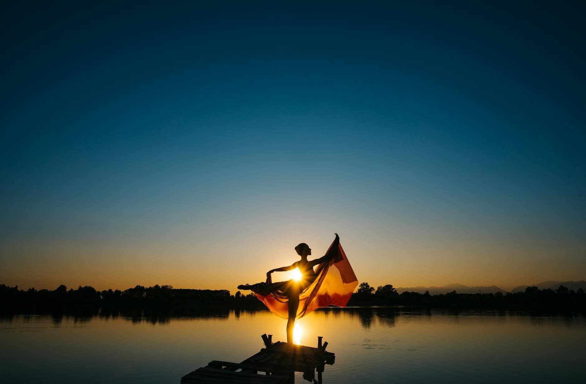woman standing in front of body of water under clear blue sky