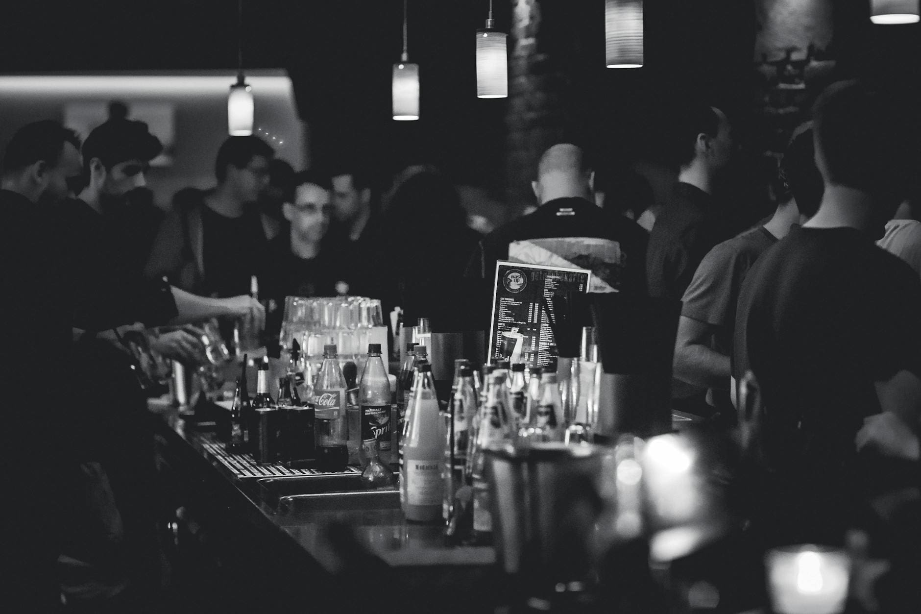 grayscale photography of bottles on top of table