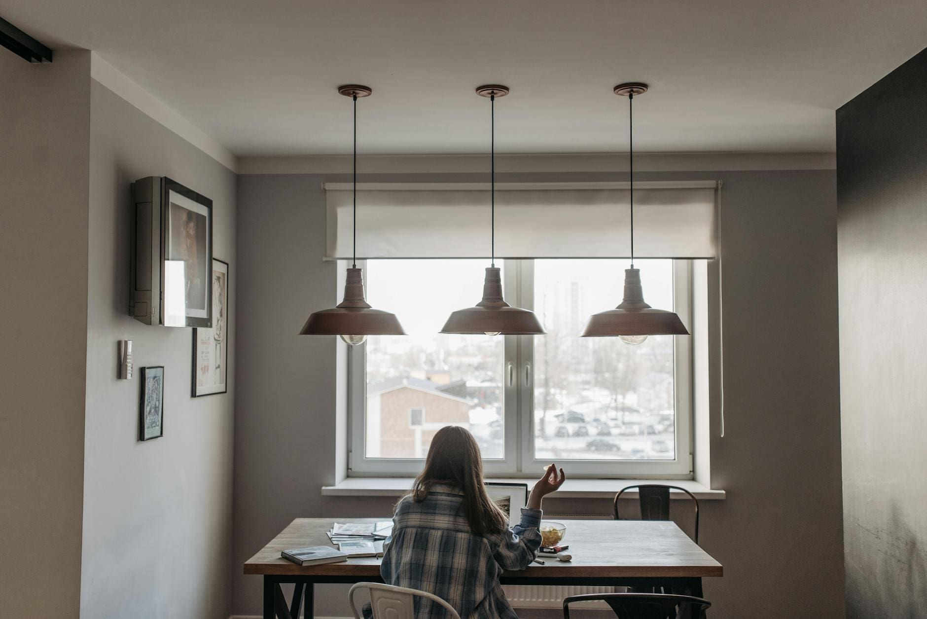 woman using laptop in front of window